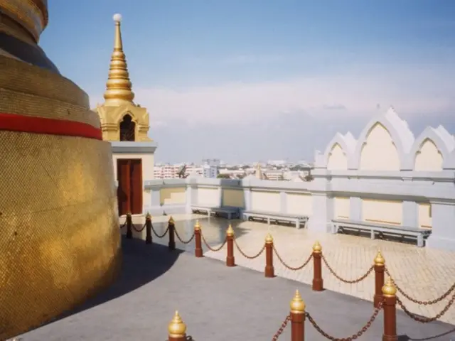 It is the picture of a terrace of some architecture and in the background there are many buildings.