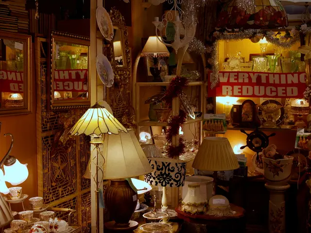 In this image, we can see some lamps, glasses and plates. There are photo frames on the left side...